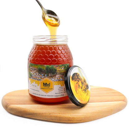 raw honey with spoon of honey on wooden board with lid