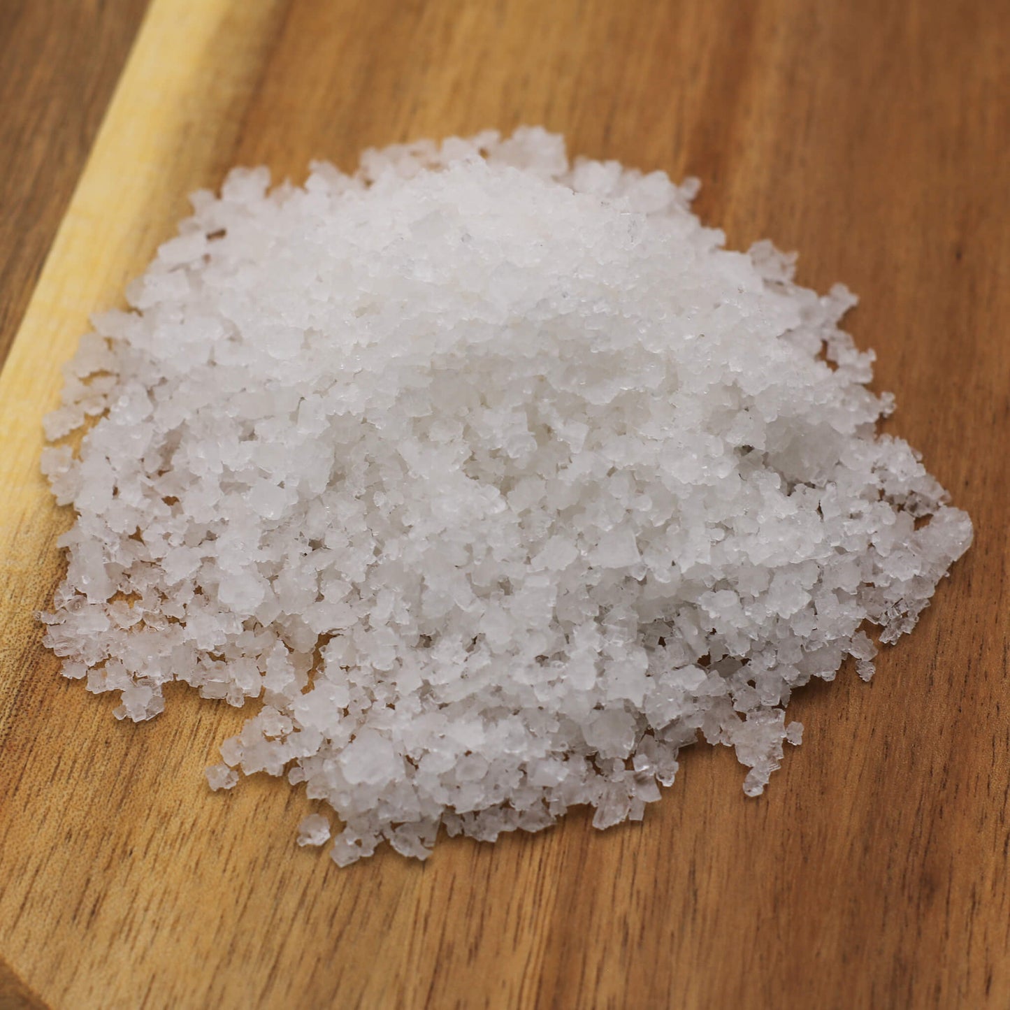 White necton sea salt on a wooden board