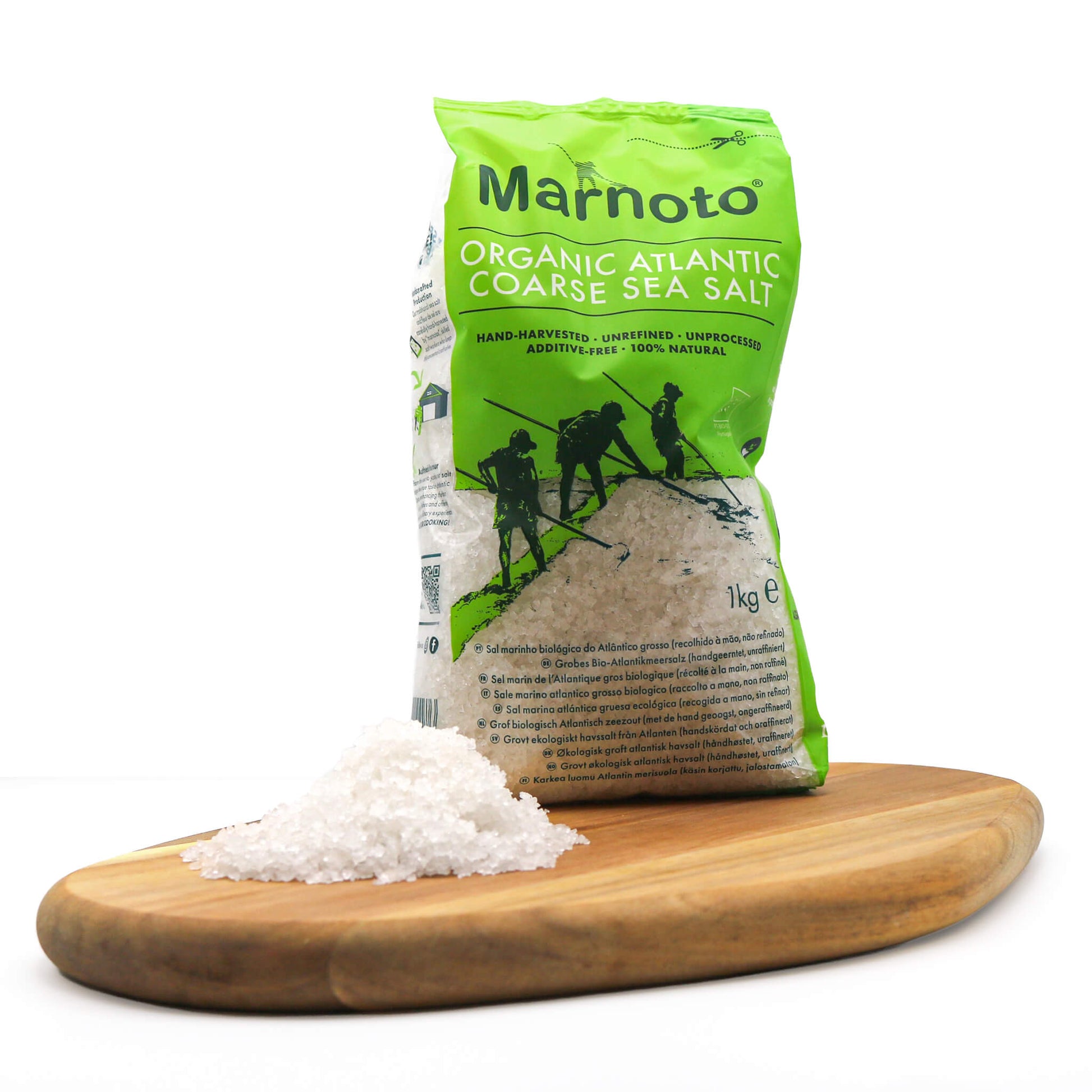 Marnoto organic Atlantic coarse sea salt packaging on a wooden board with salt.